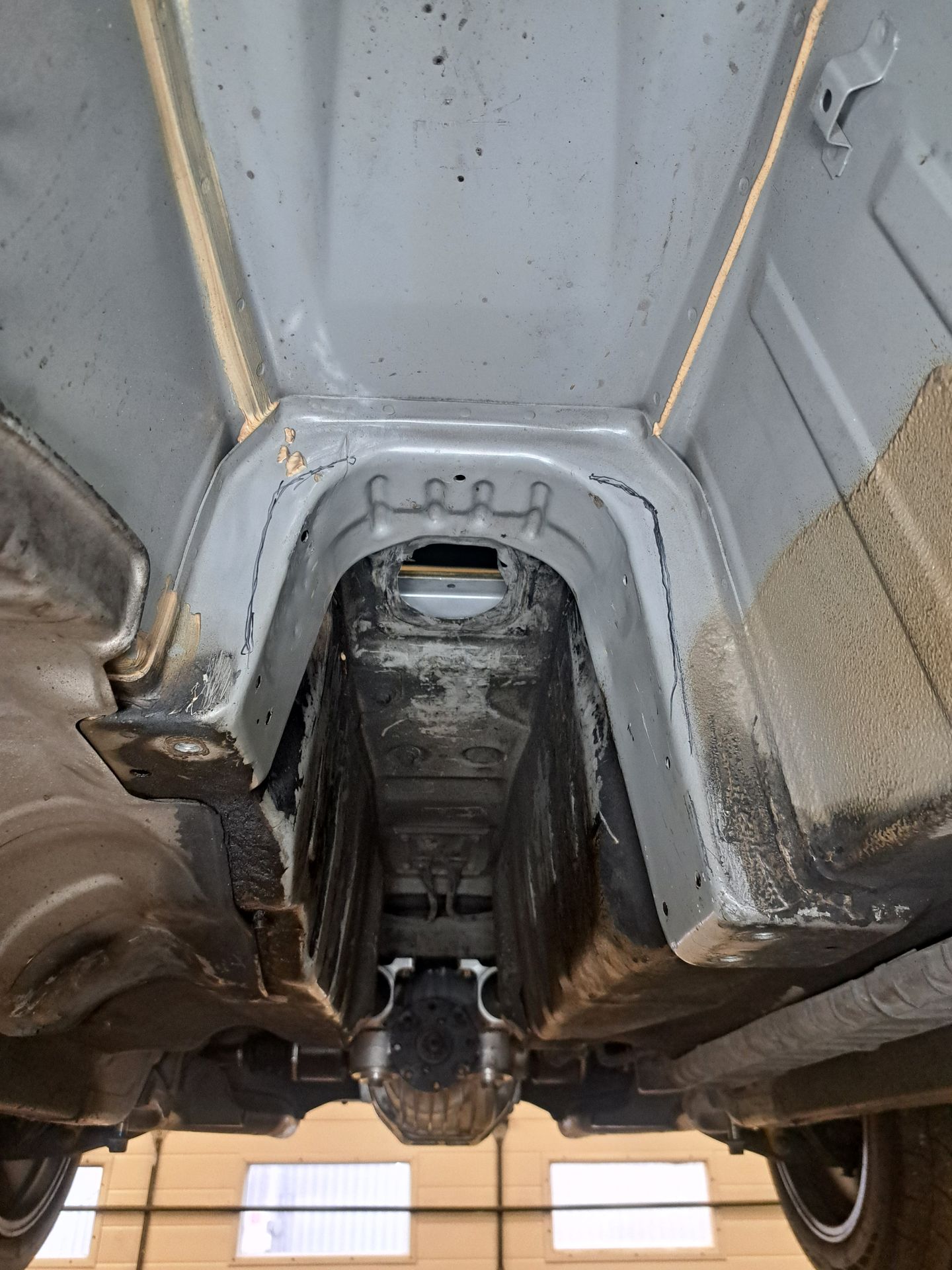 Marked outline around the Honda S2000 transmission tunnel before cutting